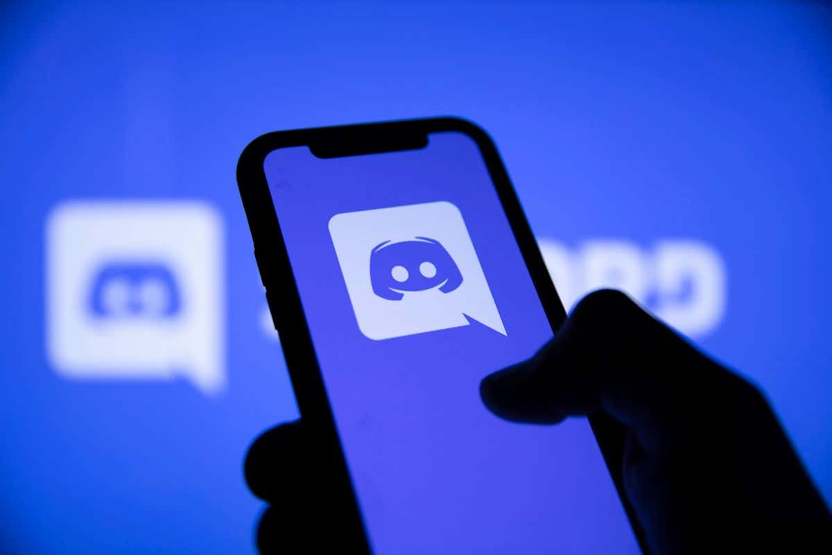 A smartphone displays the Discord logo