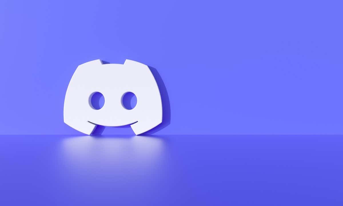 A white Discord logo sits on a purple surface, reflecting slightly