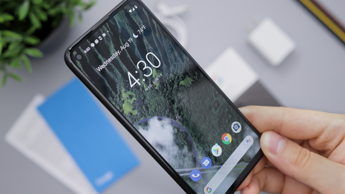 A hand holds a smartphone displaying a lock screen showing the time 4:30, Wednesday, August 19, and 74°F